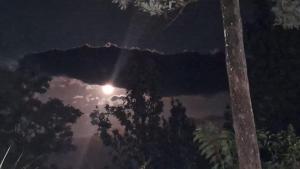 a reflection of the sun in the water at night at White House Holiday Inn in Passara
