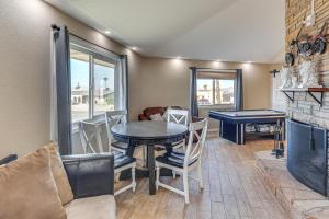 a dining room with a table and a ping pong ball at 3 Mi to Lake Havasu Family Home with Game Room in Lake Havasu City +18 photos