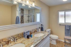 a bathroom with two sinks and a mirror and a toilet at 3 Mi to Lake Havasu Family Home with Game Room in Lake Havasu City
