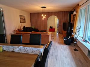 a living room with a couch and a table at Peaceful villa in nature with own beach in Hindås