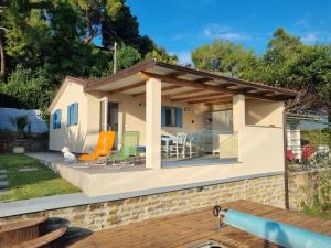 a small house with a patio with orange and green chairs at Luna's Seaview Residence - Ankaran in Ankaran