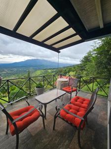 a patio with a table and chairs and a view at Cabañas El Parador in Boquete