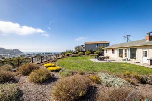 a house with a yard with plants and a fence at Entire Ocean View Home beaches hiking restaurants family activities in Pacifica