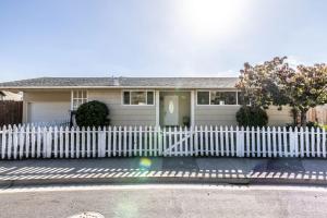 a white fence in front of a house at Entire Ocean View Home beaches hiking restaurants family activities in Pacifica