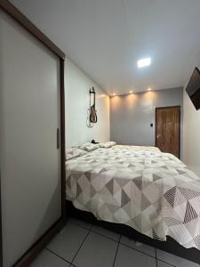 a bedroom with a large bed in a room at Casa Amazônia Belém Próxima ao Hangar COP30 in Belém