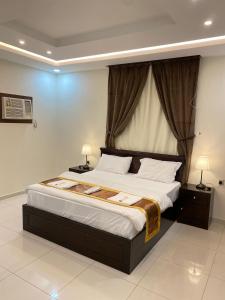 Ένα ή περισσότερα κρεβάτια σε δωμάτιο στο تاج الفخامه للشقق المخدومه إقتصادي +38 φωτογραφίες