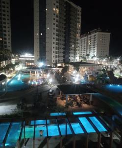 a view of a pool at night with buildings at Esclusive Resort Salinas in Salinópolis