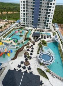 a resort with a pool and a water park at Esclusive Resort Salinas in Salinópolis