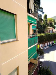 a building with a green window and a street at A&V Apartment in Santa Margherita Ligure