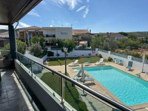 a view of a swimming pool from the balcony of a house at Alojamentos Turísticos São Torcato Moradal Turismo Espaço Rural in Estreito