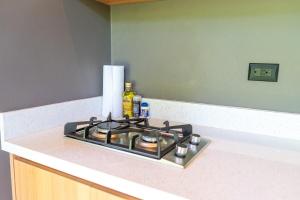 a stove top oven sitting on a counter in a kitchen at Mira Bungalow, AC & Plunge Pool near Arrecife in Punta Uva +2 photos