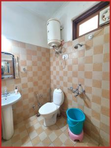 a bathroom with a toilet and a sink at Hotel Sapphire Stay- A Luxury Resort with All Room Attached Balcony and Valley View - Wifi - Restaurant - Parking and Children Play Ground Available - Best Resort in Nainital in Nainital +23 photos