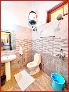 a bathroom with a toilet and a sink at Hotel Sapphire Stay- A Luxury Resort with All Room Attached Balcony and Valley View - Wifi - Restaurant - Parking and Children Play Ground Available - Best Resort in Nainital in Nainital