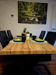 a wooden table with plates of food on it at Ferienwohnung zum Backstübchen in Altenrode +1 photo