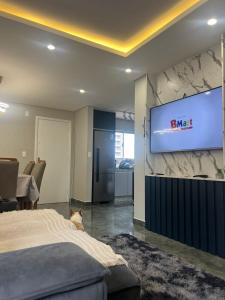 a bedroom with a bed and a tv on a wall at Apartamento praia do Gravata e prox Beto Carrero in Navegantes +18 photos