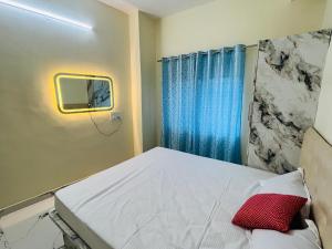 a hospital room with a bed and a window at THE ROYAL RETREAT service apartment in Chikmagalūr