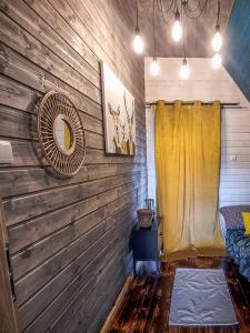 a room with a wooden wall with a mirror at Stodoły Karkonoskie in Podgórzyn +64 photos