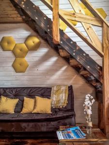 a couch in a room with a wooden ceiling at Stodoły Karkonoskie in Podgórzyn