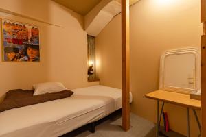 a small room with two beds and a mirror at noctarium in Gotemba