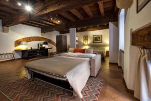 a bedroom with a large bed and a desk at Diaz 18 in Verona