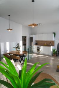 a living room with a table and a kitchen at Amber Skies Seafront Retreat in Cotillo +84 photos