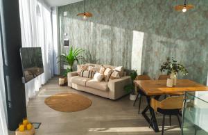 a living room with a couch and a table at Amber Skies Seafront Retreat in El Cotillo