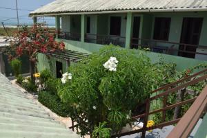 a building with flowers and plants on the stairs at Pousada Panorama do Mar in Fortaleza