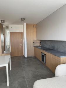 a kitchen with a counter and a table in it at Królewska 51 in Tuszyn +9 photos