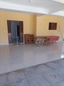 a room with a table and chairs in it at Casa Ponta de Lucena Beach in Lucena