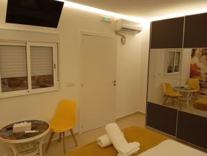 a living room with yellow chairs and a table at El Refugio del Estrecho in Algeciras