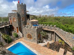an exterior view of a castle with a swimming pool at La Fortaleza De Haro in Puerto Ayora