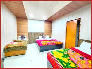a room with three beds in a room at Hotel Neelam !! Raz Nainital - Near Naini Lake And Mall Road - Budget Friendly Hotel with Wifi - Room Service and Excellent Customer Service Awarded - Book Now in Nainital +20 photos