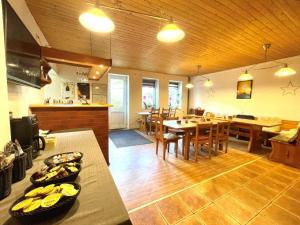 a kitchen and dining room with tables and chairs at Chata WALTEROVKA in Josefŭv Dŭl