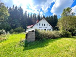 a building with a sign on the side of a field at Chata WALTEROVKA in Josefŭv Dŭl +25 photos