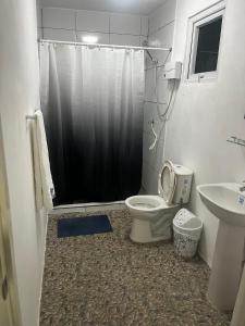 a bathroom with a shower and a toilet and a sink at The Breeze Villa in Willemstad