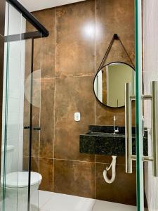 a bathroom with a sink and a mirror at Kuri Hotel in Padre Bernardo