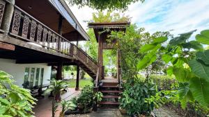 a wooden staircase leading up to a house at Was Na Yajai 