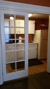 a kitchen with white cabinets and a window at Captain Hugo's Guesthouse STR26-36 in Rockland
