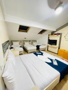a bedroom with two beds and a living room at Taksim Precious Gold hotel in Istanbul