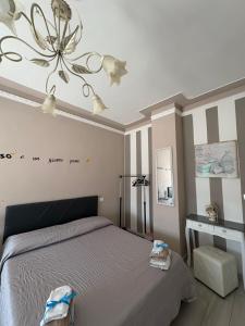 Un dormitorio con una cama y una lámpara de araña. en CASA PANDORA, en Arezzo