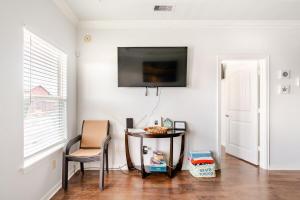 a room with a table and a television on a wall at Welcome To Sarenity a 3Bd 2Bth home in Crystal Beach, Tx in Bolivar Peninsula
