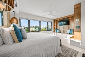a bedroom with a large bed and a large window at Knot A Basic Beach House in Bailey Hall +163 photos