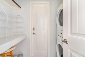 a white laundry room with a washer and dryer at Welcome To Sarenity a 3Bd 2Bth home in Crystal Beach, Tx in Bolivar Peninsula +41 photos