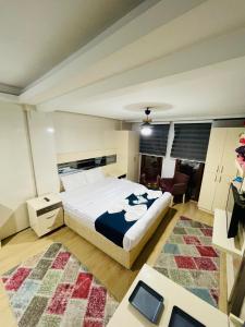 a bedroom with a king sized bed and a living room at Taksim Precious Gold hotel in Istanbul