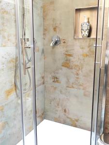 a shower with a glass door in a bathroom at Paloma13 in Ferrara +25 photos