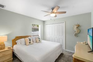 a bedroom with a bed and a ceiling fan at La Dolce Vita in North Port +14 photos