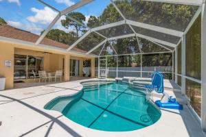 an indoor swimming pool with a glass roof at La Dolce Vita in North Port
