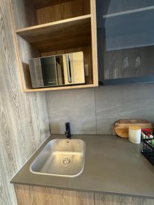 a kitchen counter with a sink and a microwave at 1128 Executive Studio, The Capital Triology in Pretoria +20 photos