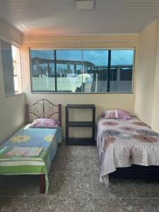 Ένα ή περισσότερα κρεβάτια σε δωμάτιο στο Casa Alto da Sereia