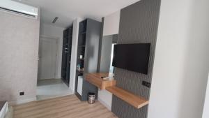 a living room with a flat screen tv on a wall at Karadut Otel Nemrut in Karadut
